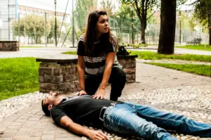 A woman looking for aid while with an unconscious man.