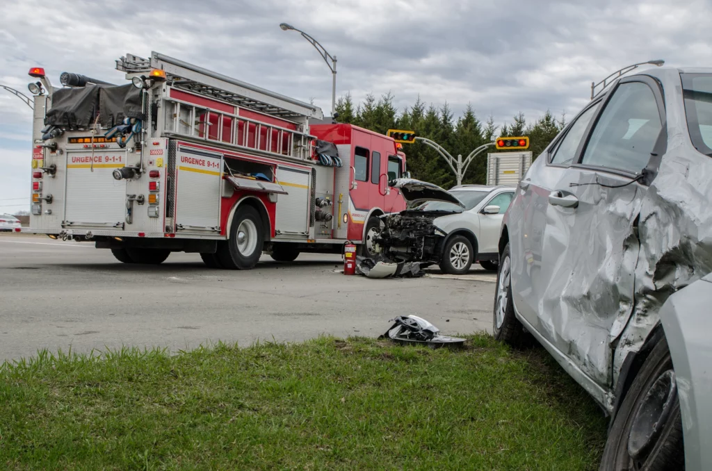 A car accident scene with a firetruck in the middle.