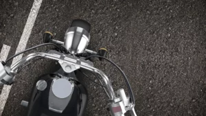 A top shot of a motorcycle driving down the road.