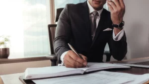 A lawyer on the phone while taking notes.