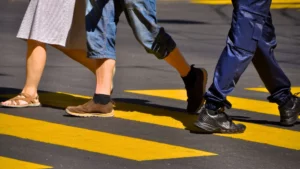 A closeup of people crossing a crosswalk.