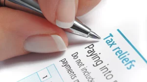 A person filling out a tax relief application.