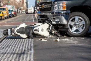 A motorcycle crash scene with a car.