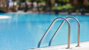 A hand rail at a swimming pool.