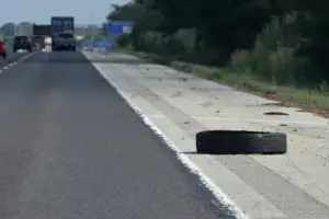 A tire on the side of a freeway.