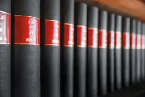 A row of black and red law books.
