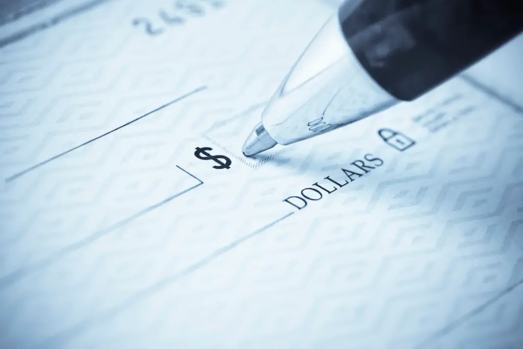 A pen about to fill out a check.