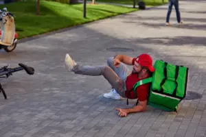 A food delivery biker falling.