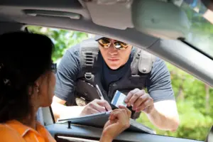 A police officer giving out a ticket.