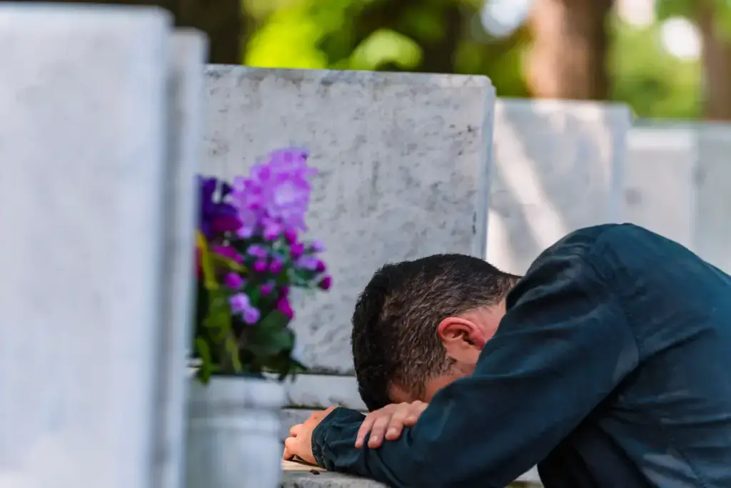 A man crying for his loss of a loved one.