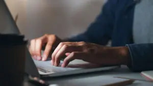 A person typing on a computer.