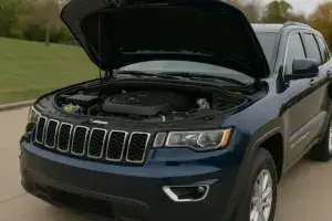 A Jeep Grand Cherokee with the hood up.