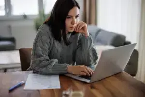 A woman researching what kind of lawyer she needs.