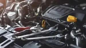 A car engine with tools on top of it.