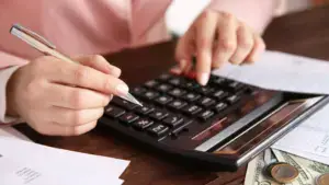 A person calculating their costs.