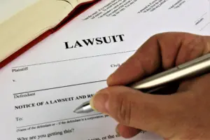 A person filing out a lawsuit document.