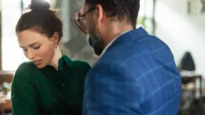 An angry man getting up in a woman's face.