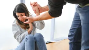 A woman fending off a man grabbing her. 
