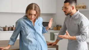 A abused looking woman trying to get away from an angry man.