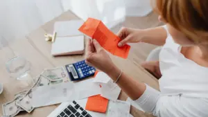 A woman looking through her receipts. 